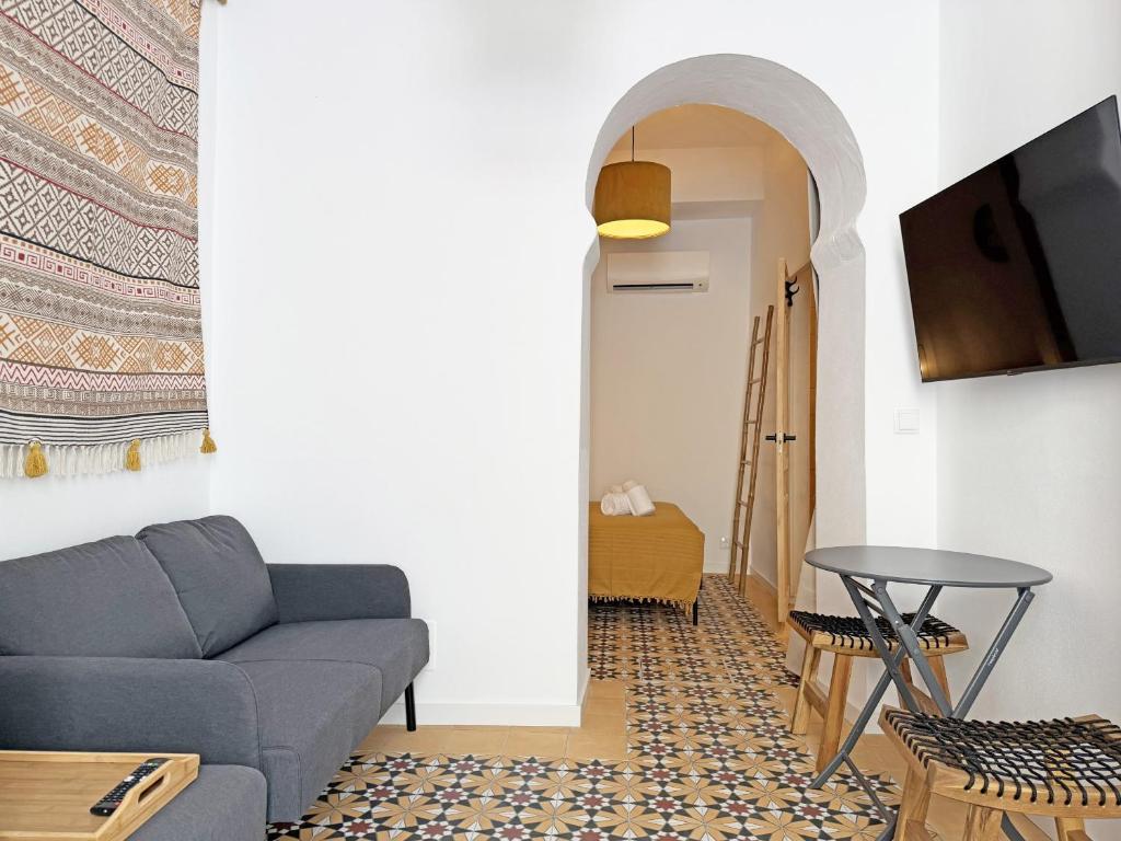 a living room with a couch and a table at Yellow Flamingo Studio Fuseta in Fuzeta