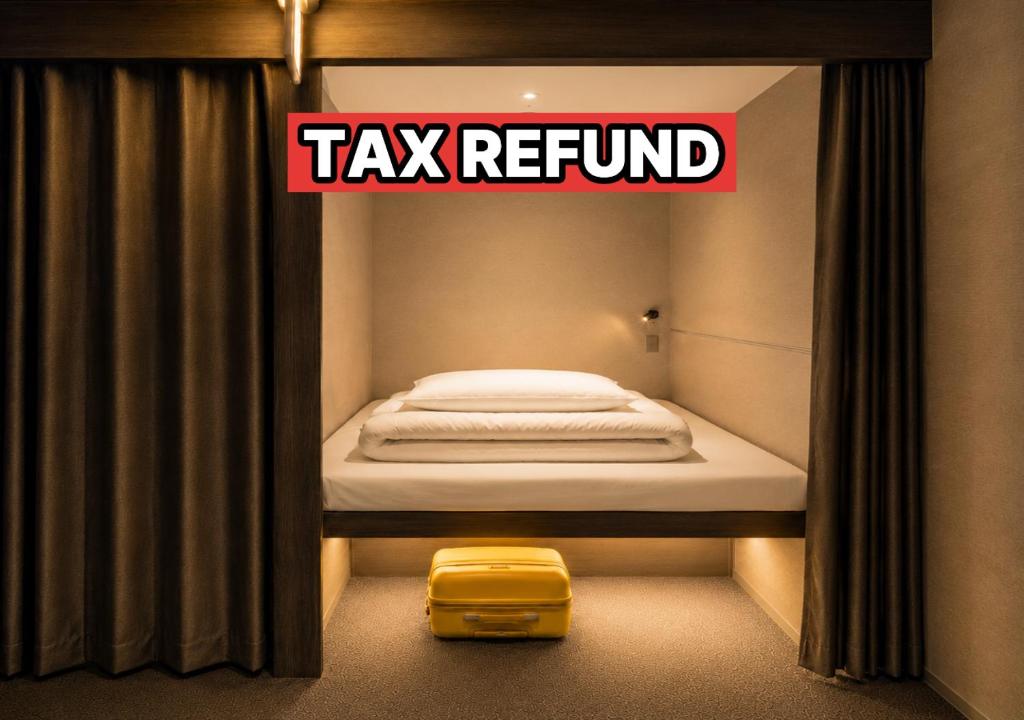 a room with a taxi refund sign and a yellow suitcase at OstelloMaree 오스텔로마레 Tax Benefit in Seoul