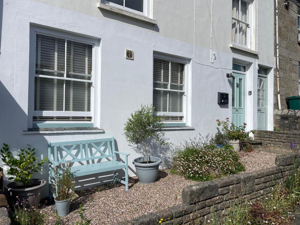 a blue bench sitting outside of a house at Apartment in Constantine in Constantine