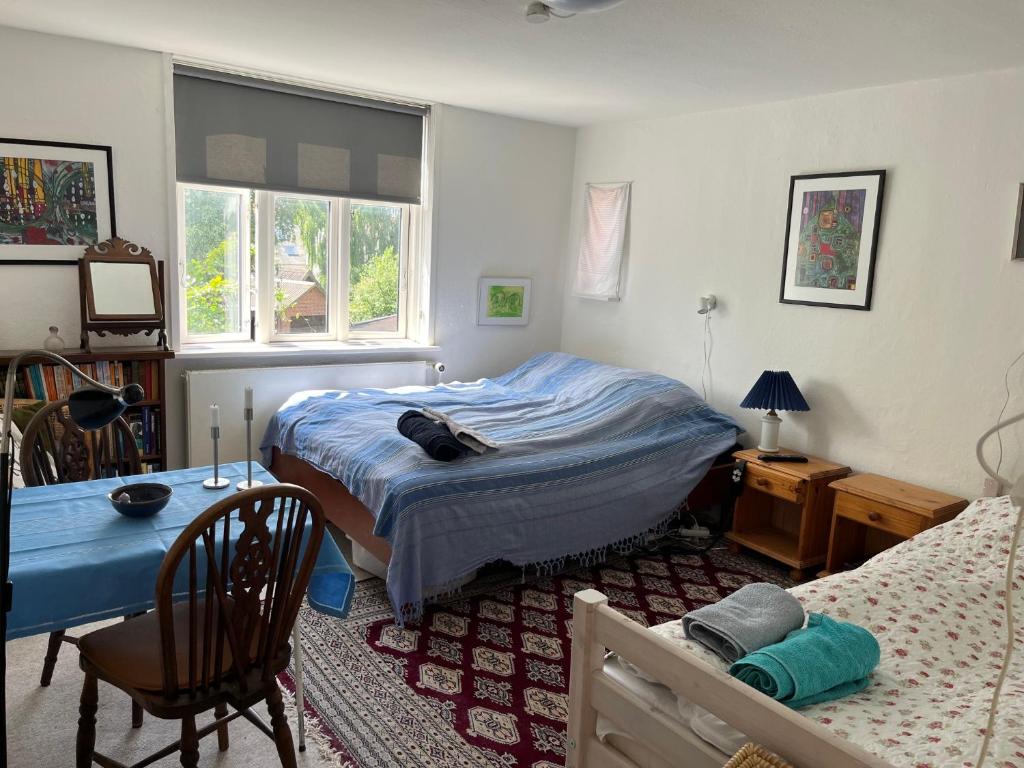a bedroom with a bed and a desk and a table at Friisenborg in Jelling