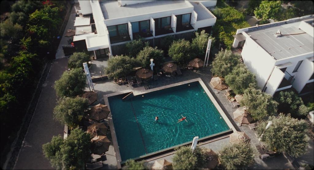 two people swimming in a swimming pool in a house at Pereh Mountain Resort in Gadot
