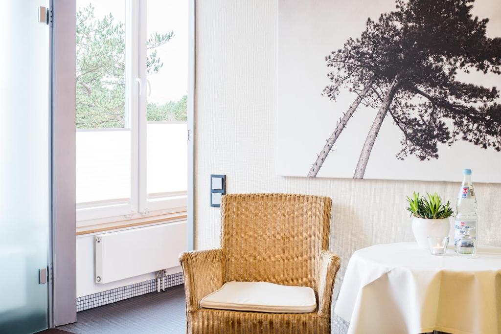 a dining room with a table and a chair at Hotel Windschur in Sankt Peter-Ording