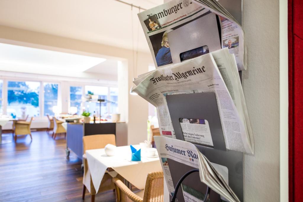 a newspaper hanging on a wall in a restaurant at Hotel Windschur in Sankt Peter-Ording