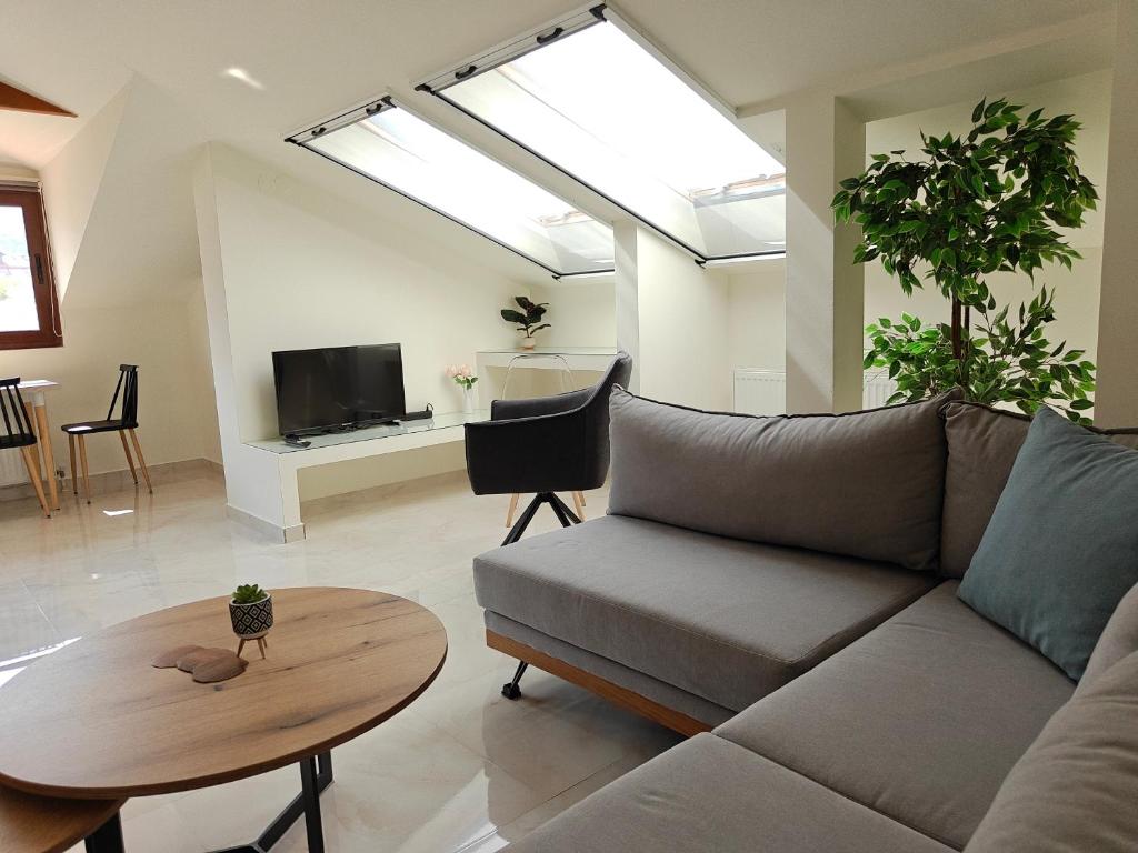 a living room with a couch and a table at Luxury suite with Olympus and sea view in Litochoro