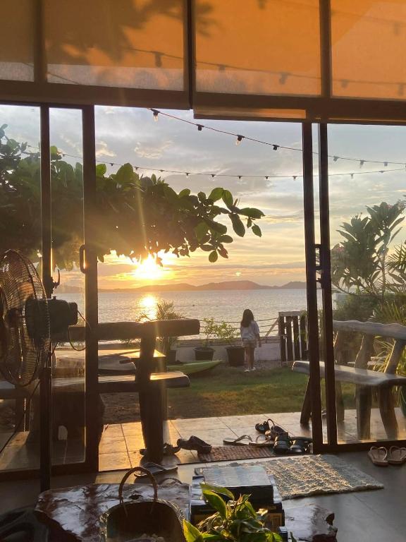 a view of the ocean from a house with the sunset at The Reef Anilao in Mabini