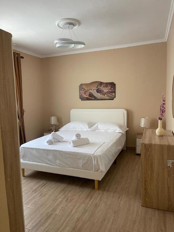 a bedroom with a white bed in a room at Berat Central Home in Berat