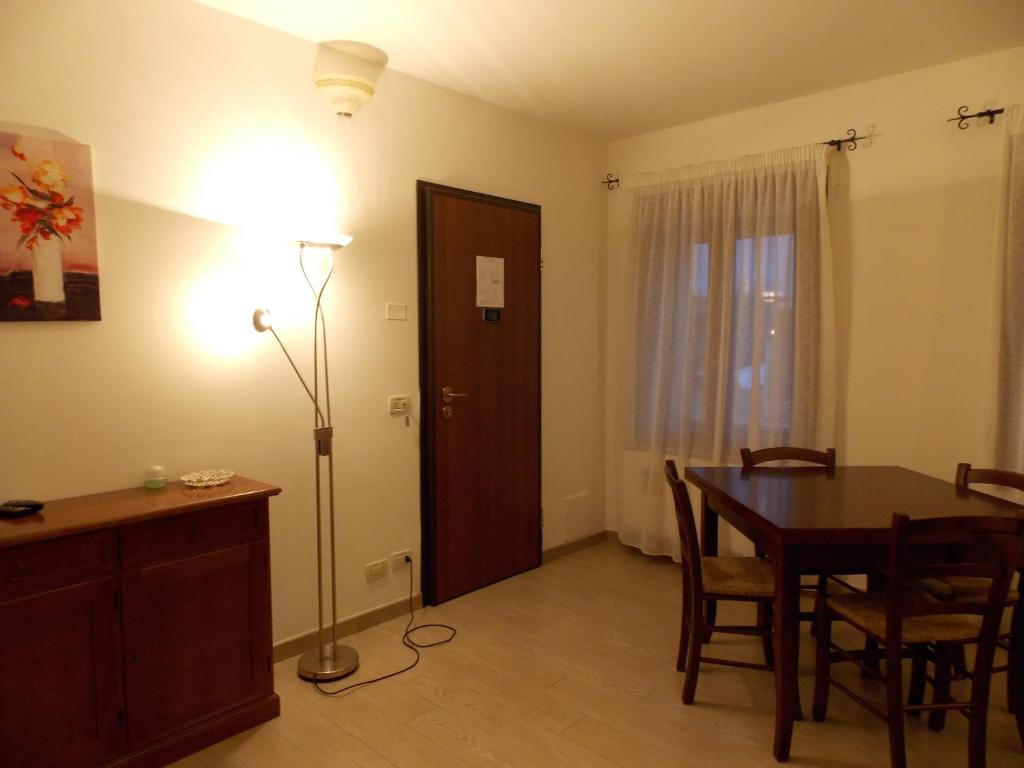ein Esszimmer mit einem Tisch und einer Stehlampe in der Unterkunft Agriturismo Alla Corte in Vicenza