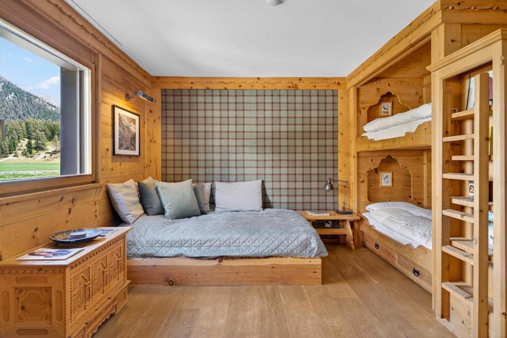 a bedroom with a bed and two bunk beds at Alpine Studio Flat near Sankt Moritz in Celerina
