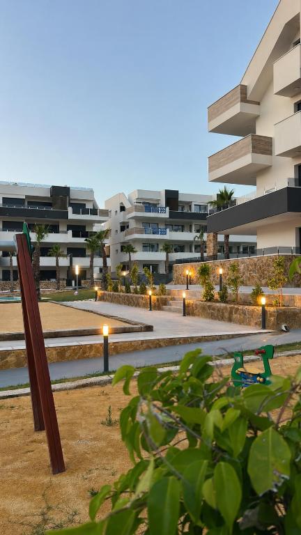 a park with a bench in front of a building at Casa Lauri in Orihuela Costa