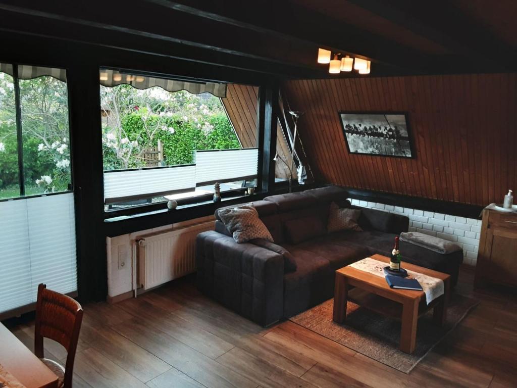 a living room with a couch and a table at Haus Maya H-12 in Butjadingen
