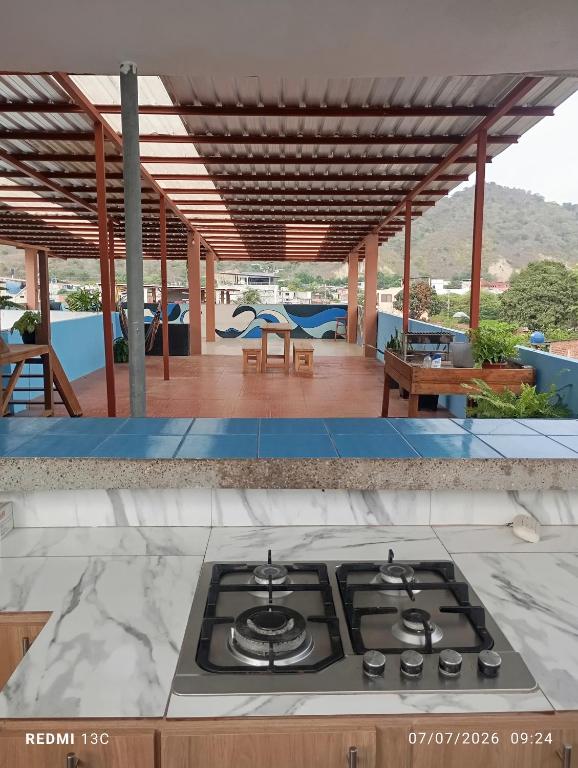 a kitchen with a stove top on a patio at Yemayá hostal in Puerto López