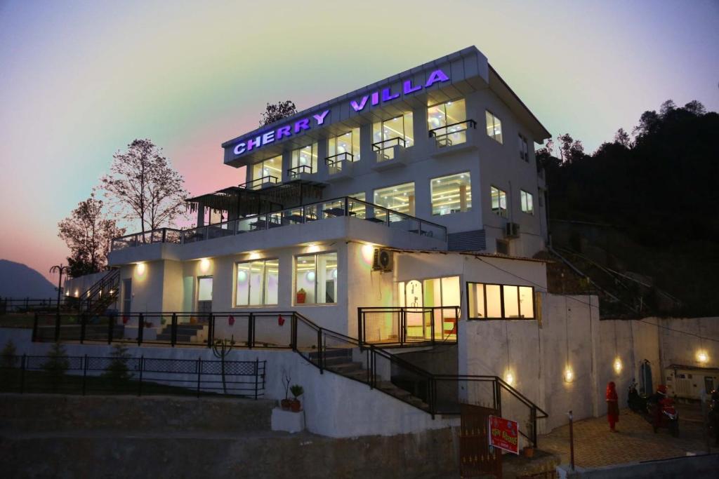 a building with a sign on top of it at Cherry villa in Manamaiju