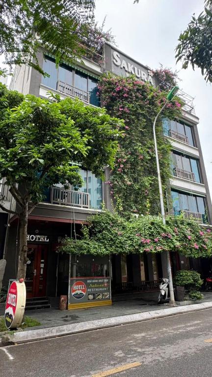 a large building with plants on the side of it at Sakura building hotel & restaurand in Hải Dương