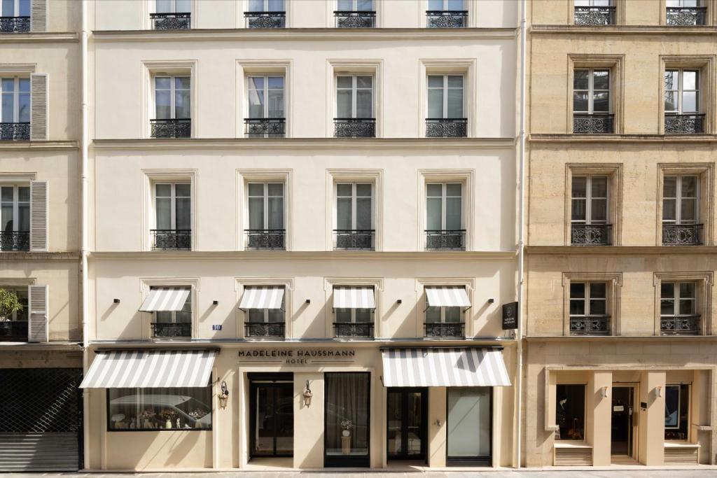 a facade of a building with windows at Hôtel Madeleine Haussmann in Paris