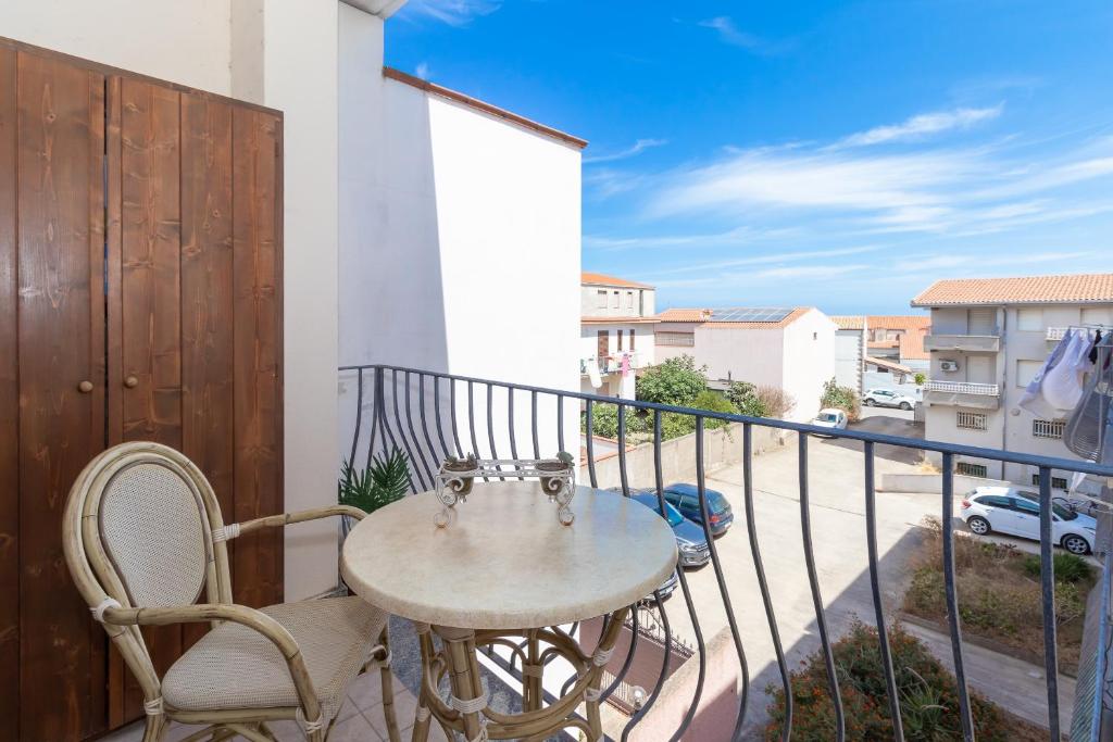 a table and chairs on a balcony with a view at Casa Pia in Valledoria