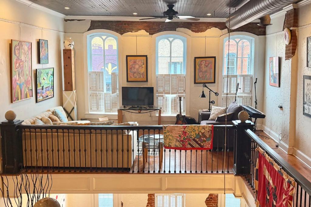 a living room with a couch and a tv at Steps to Historic Riverfront: Chic Dtwn Condo! in Paducah