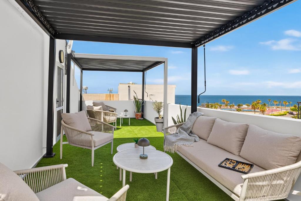 a living room with a couch and a table at Coast Suites in Alcalá