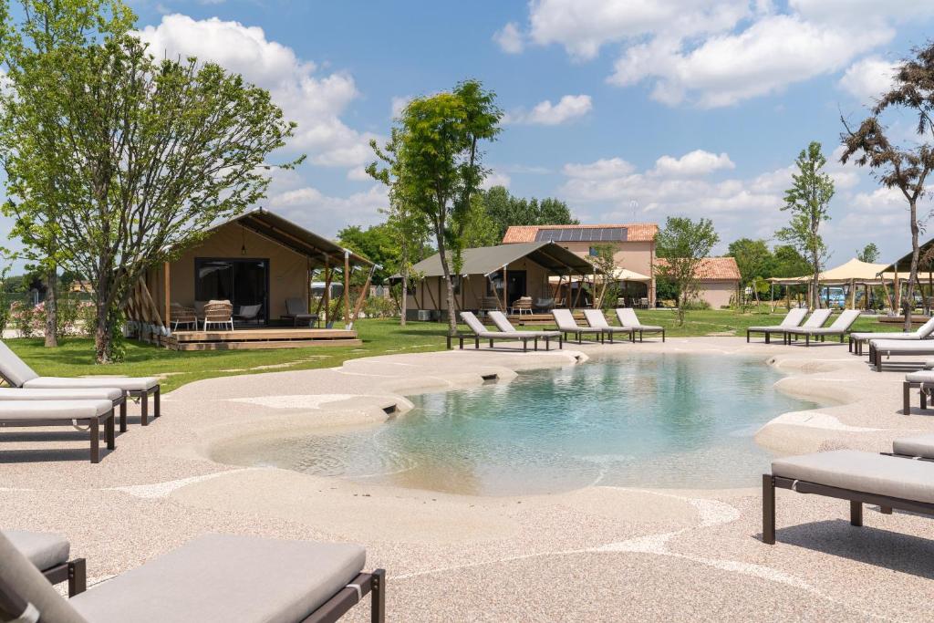 a swimming pool with lounge chairs in a resort at Glamping Tenuta Ca'Nova in Mestrino