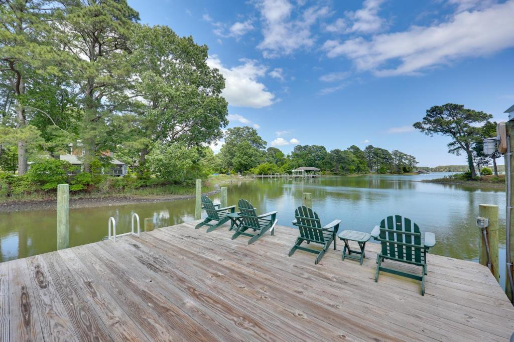 a group of chairs sitting on a dock next to a river at Pool, Dock + Rooftop Views! Bohannon Getaway in Bohannon