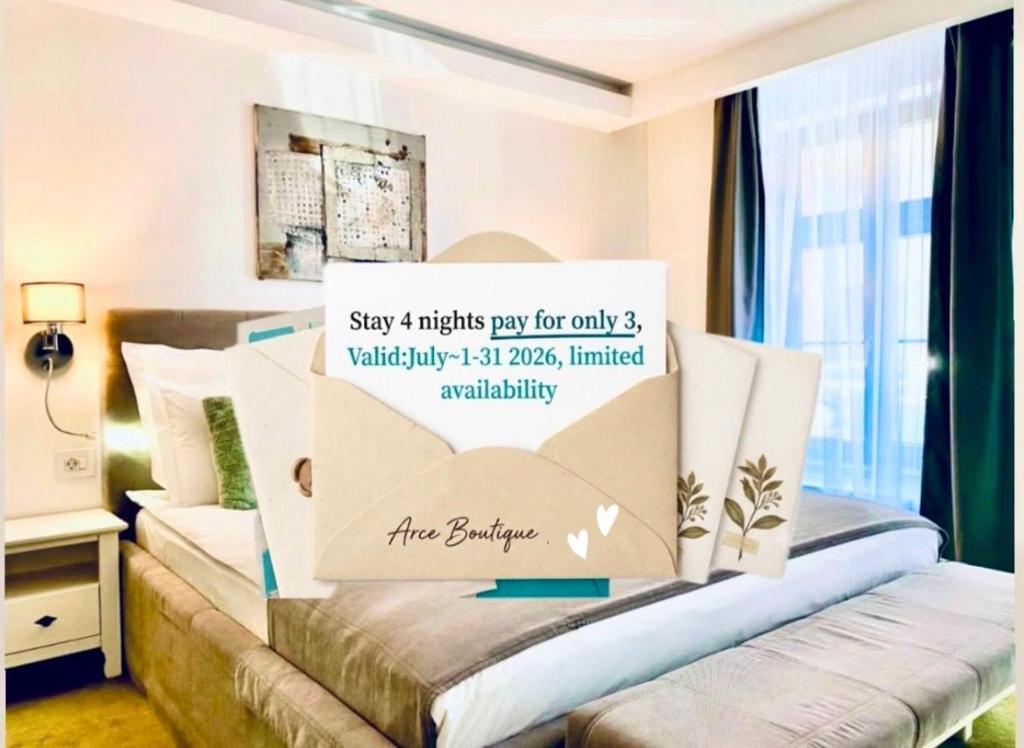 a bedroom with a bed with a sign on it at Arce Boutique in Braşov