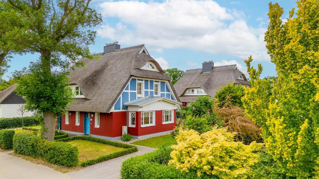 a red and blue house with a gray roof at Jade 1 in Born