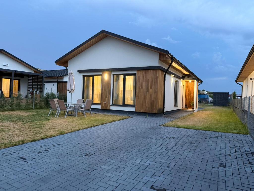 a home with a patio and a house at Sky Residence House in Cluj-Napoca
