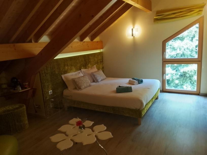 a bedroom with a bed with a flower rug on the floor at Compagnie des gites de luxe in Gérardmer