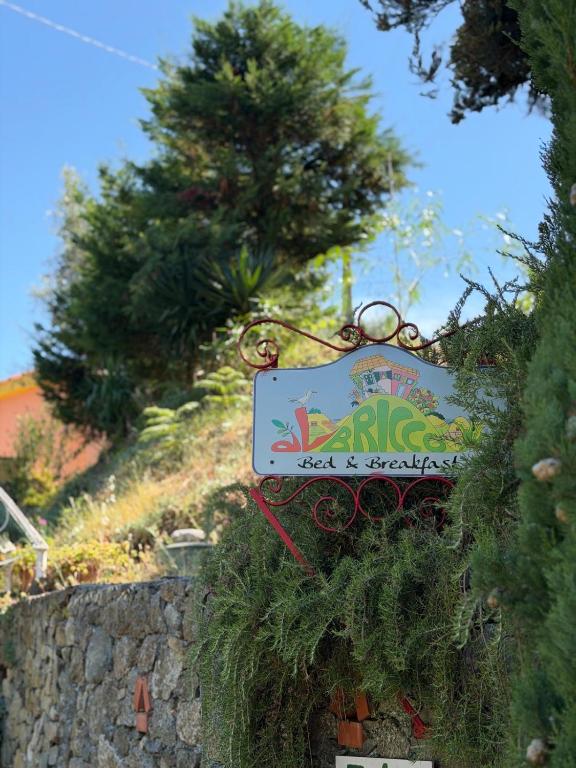 a sign for a restaurant on a stone wall at B&B Al Bricco in Albisola Superiore