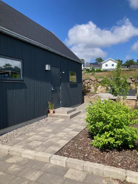 a house with a walkway next to a building at Friluftsstigen Cabin in Falkenberg