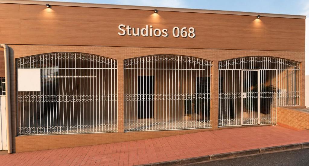 a building with three gates on the side of it at Modern and fully equipped studios in Bosque, downtown area in Rio Branco