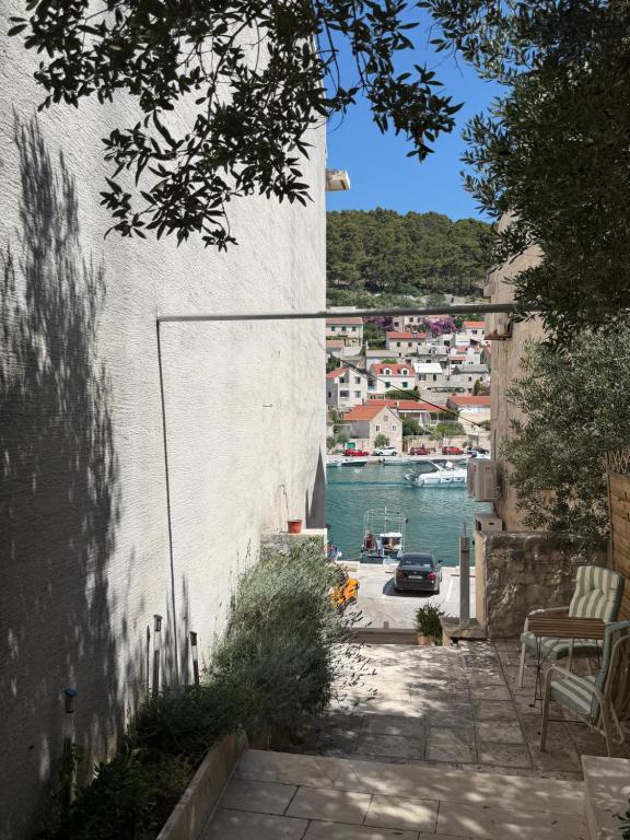 a view from the side of a wall with a harbor at Apartmani Brač in Pučišća