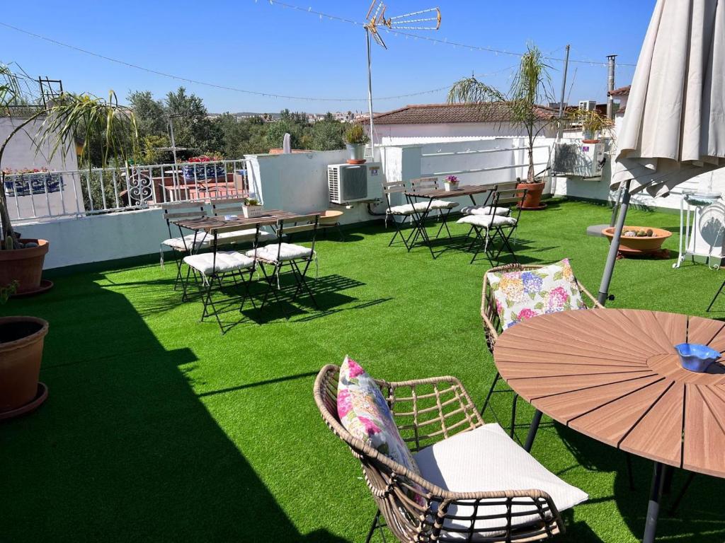 a patio with tables and chairs and an umbrella at Puertas de la Catedral in Córdoba