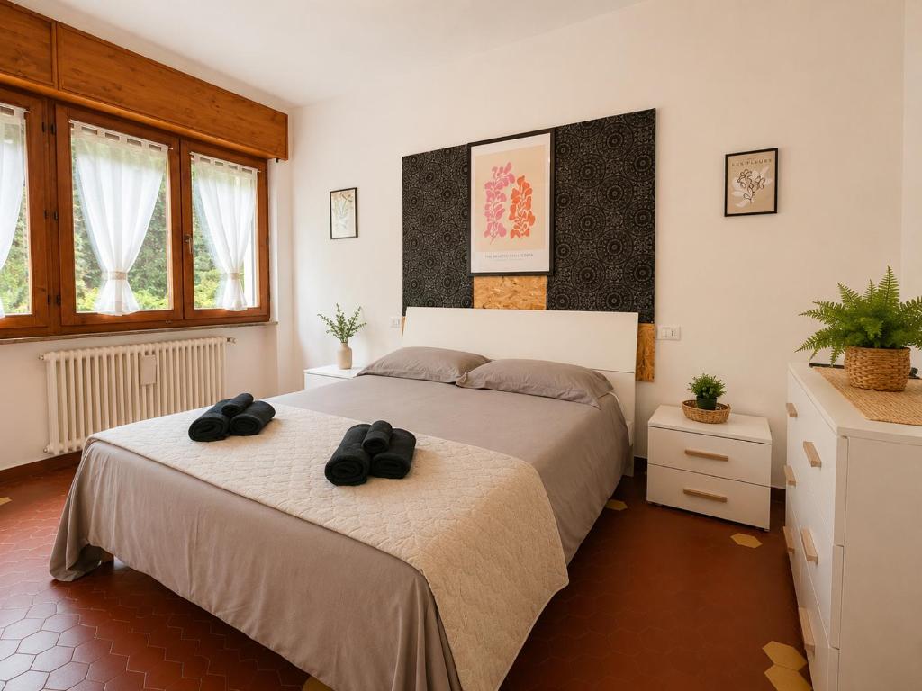 a bedroom with two beds with black shoes on them at Sunflower Apartment in Dogna