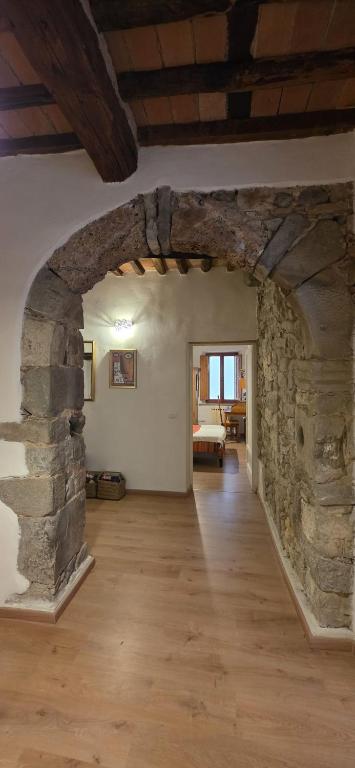 ein großer Raum mit einer Steinwand und einem Wohnzimmer in der Unterkunft La Volta Garibaldi in Barga