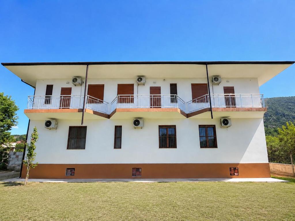 a building with balconies on the side of it at Villa Kalaj in Baks-Rrjoll