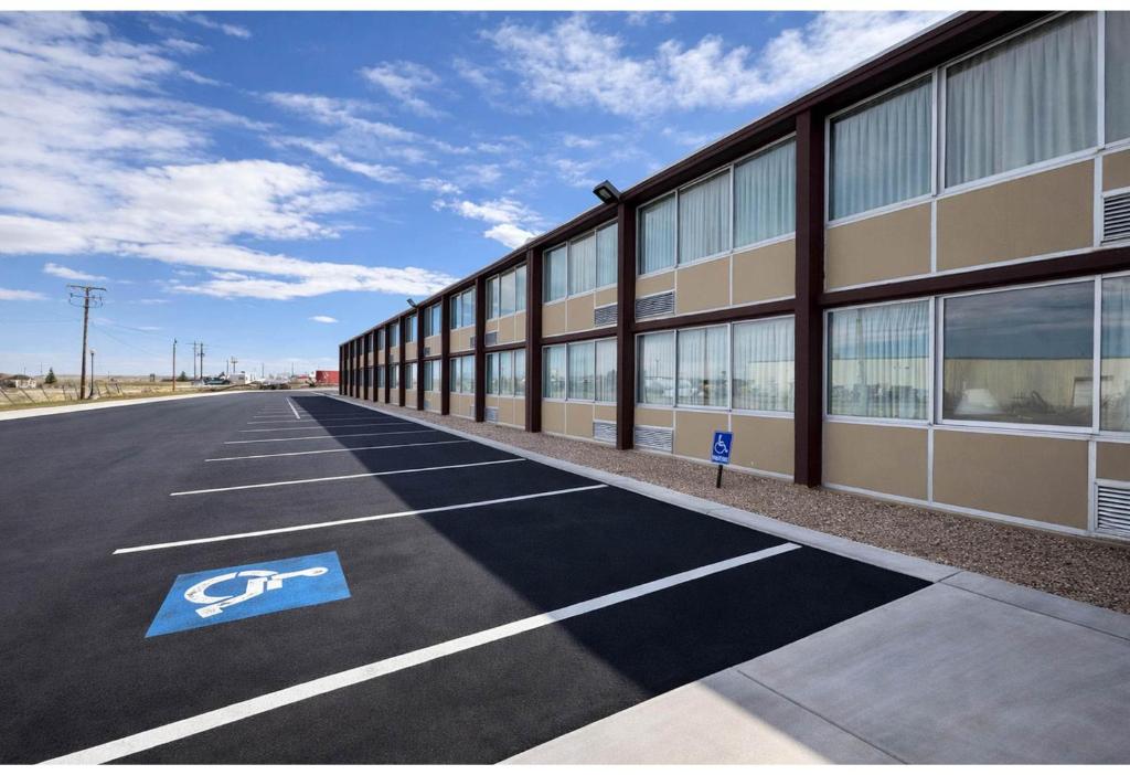 an empty parking lot in front of a building at Studio 6 Suites Rawlins WY in Rawlins