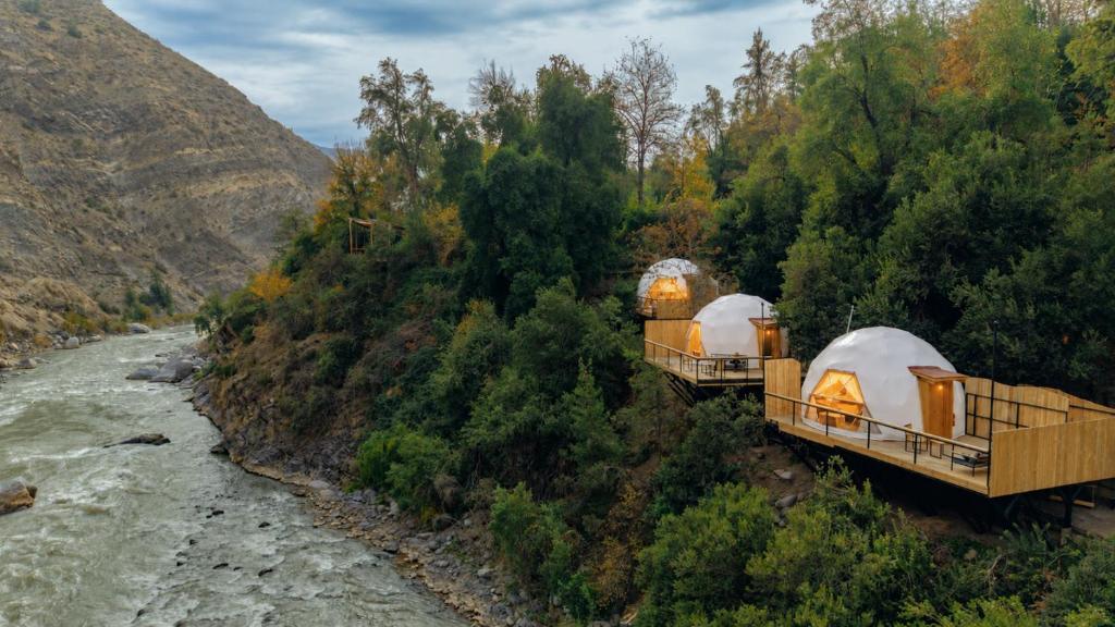 two tents on a bridge next to a river at Cascada de las Animas in San Alfonso