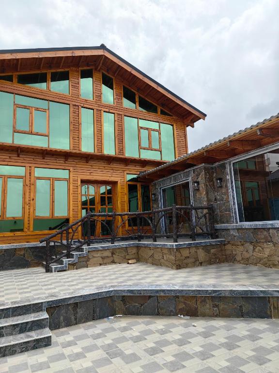 a large wooden house with a large patio at اكواخ لاكجري ابها in Abha