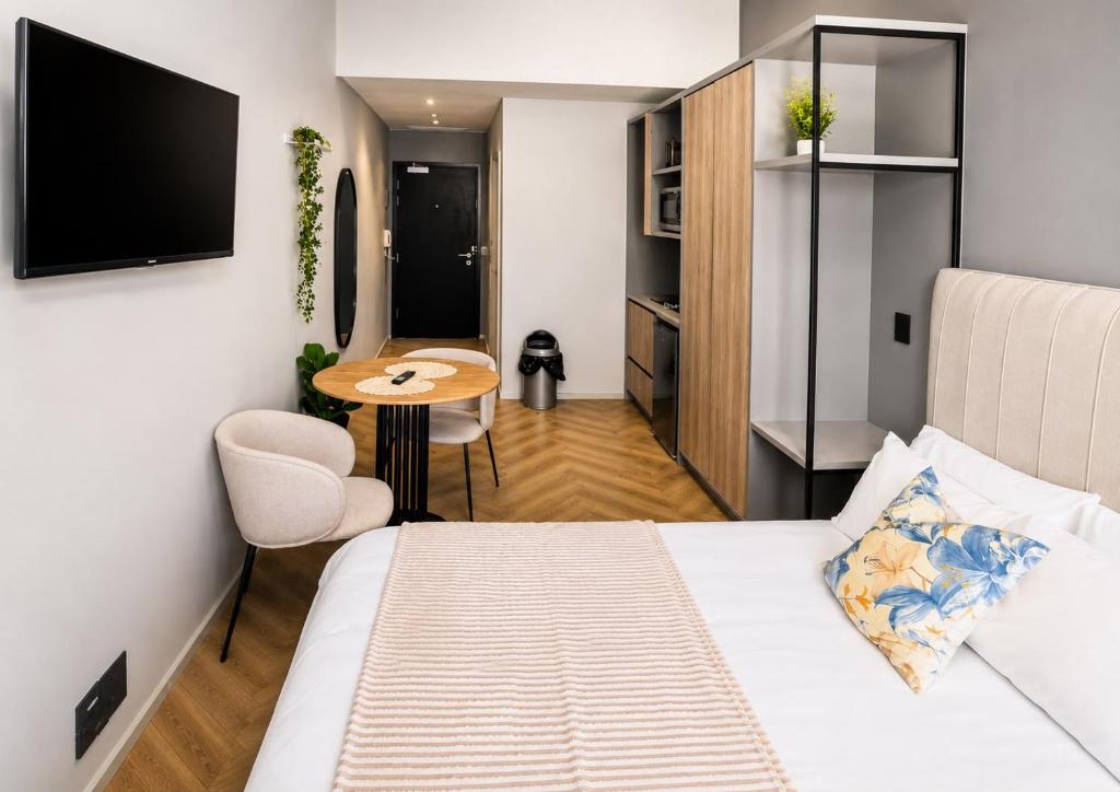 a small room with a bed and a table at One Thibault Hotel - Business Studio in Cape Town