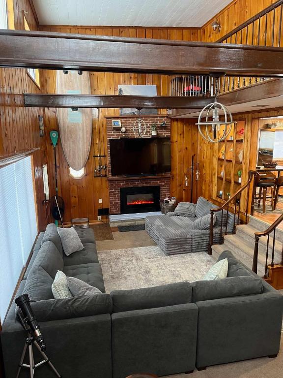 a living room with a couch and a fireplace at Cozy Waterfront Cottage in Beaverton