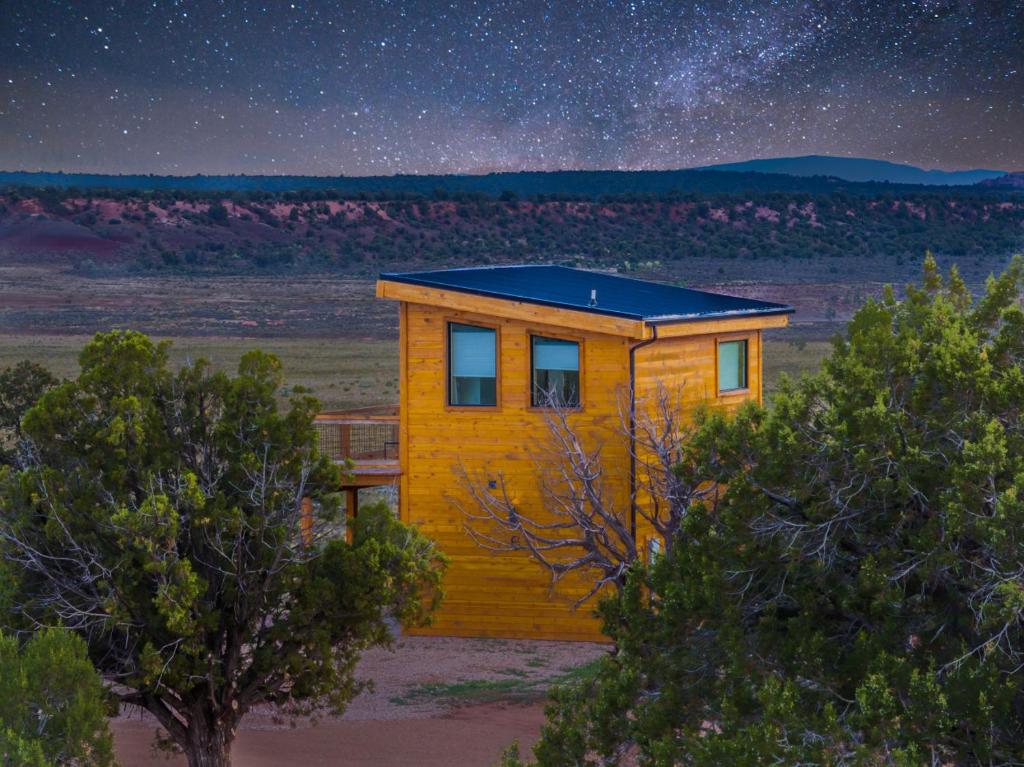 a tiny house in the middle of the desert at night at Tiny Cabin #5 at The Cedars in Kanab