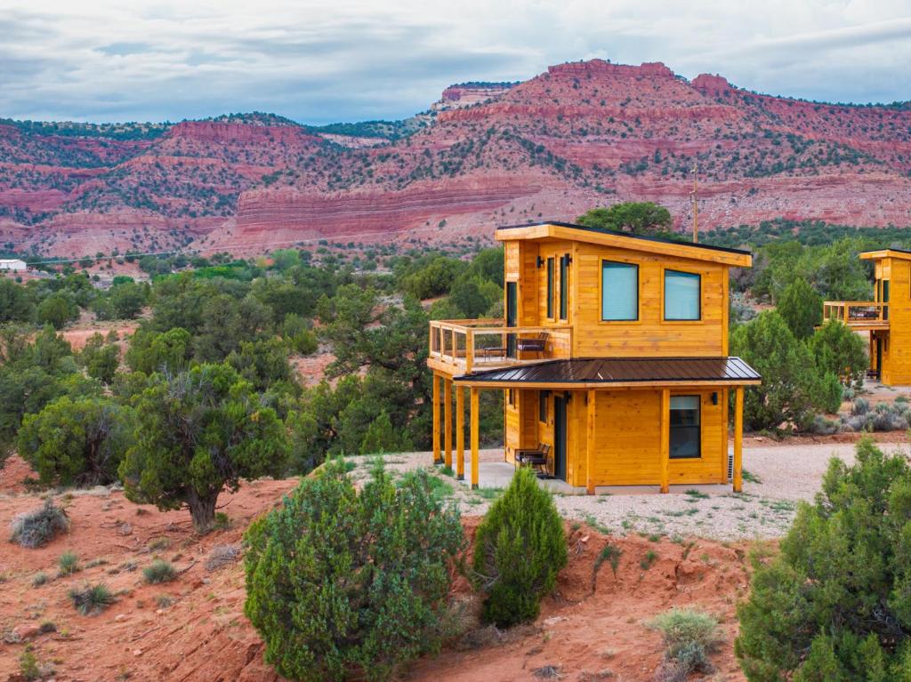 a house in the desert with mountains in the background at Tiny Cabin #7 at The Cedars in Kanab