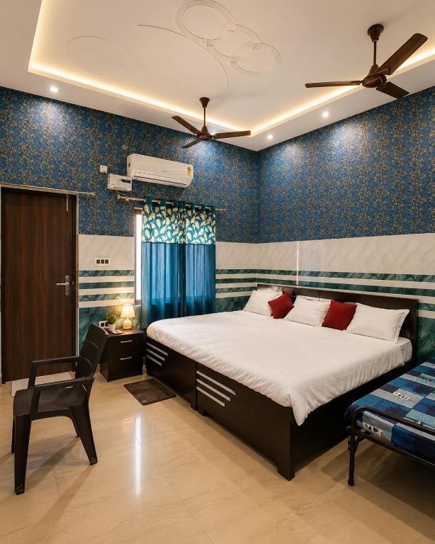 a bedroom with a bed and a chair in it at Bholenath Guest House 500 Mitter From Shree Ram Manidr in Faizābād