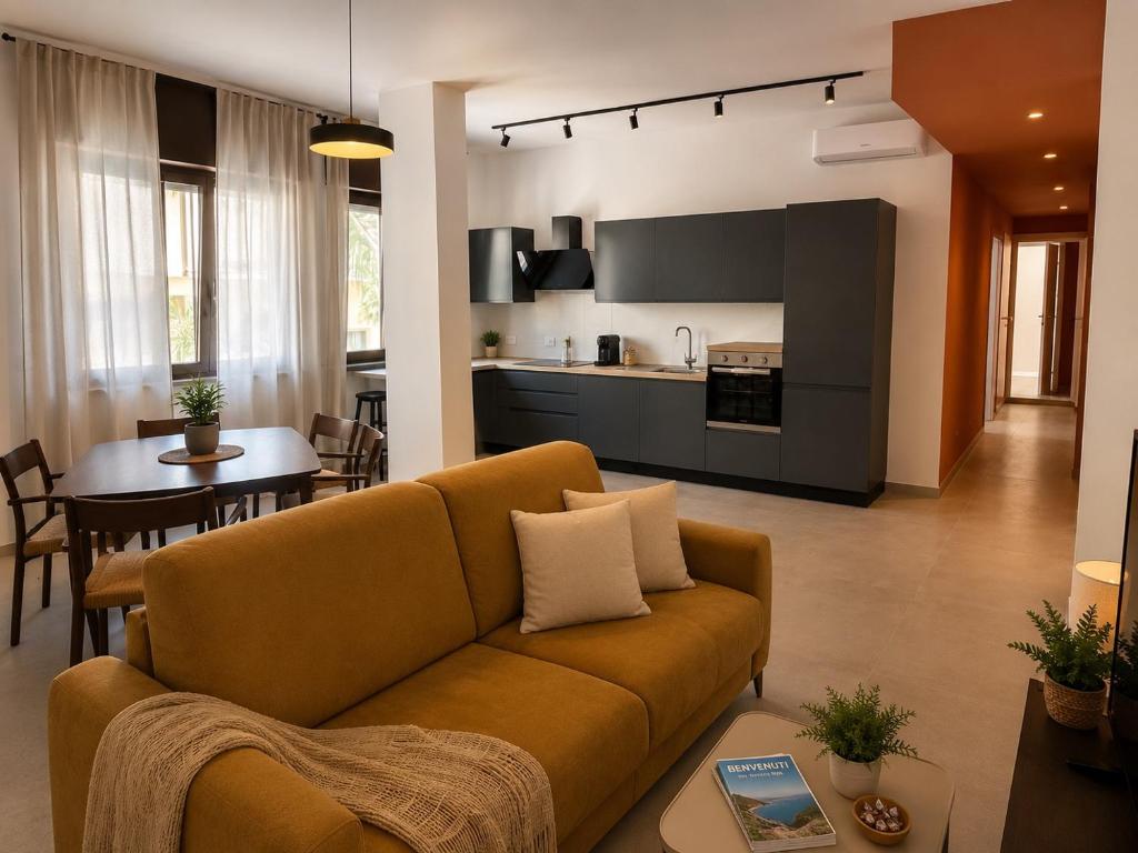 a living room with a couch and a kitchen at Casa Pelagos in Brindisi