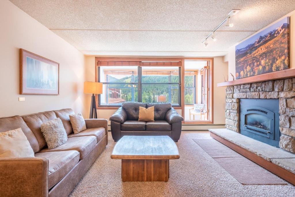a living room with a couch and a fireplace at Village Square West 353 in Copper Mountain