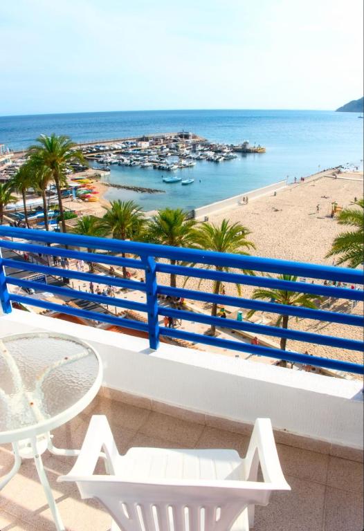 a balcony with a table and a view of the beach at Apartamentos la barca in Benidorm