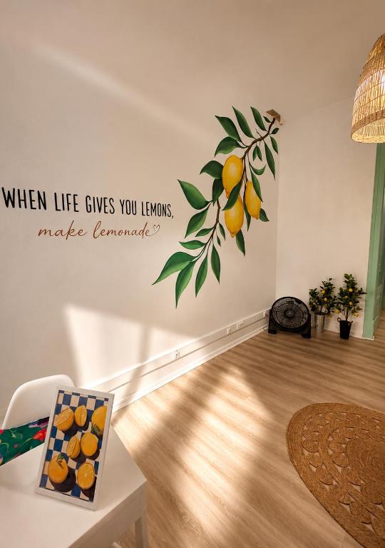a wall with a sticker of an orange tree on it at Maria's in Faro