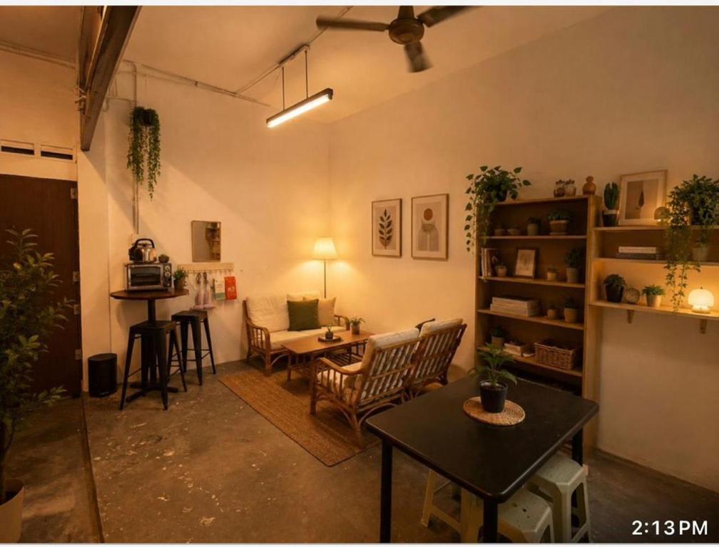 a living room with a table and chairs at F1 Riverside Mee Udang in Malacca