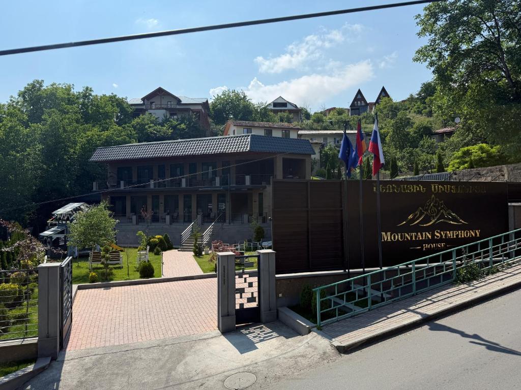 a building with a sign for the mountain institution at Mountain Symphony House Dilijan in Dilijan