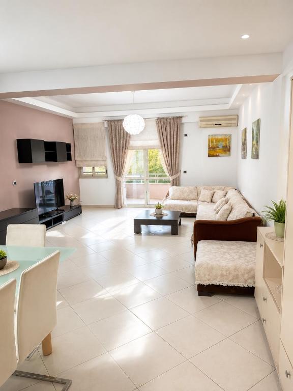 a living room with a couch and a table at Orikum Beach Loft in Orikum